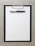 Template of white paper with a ballpoint pen on light grey concrete background in a black tablet with a clip. Concept of