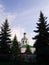 Temple against the sky among the firs