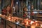 Temple and candles lit by tourists inside the Batu Caves in Kuala Lumpur, Malaysia. Batu Caves are located just north of Kuala Lum