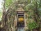 Temple covered with Banyan Tree roots, Luang por Nil Manee banner in the front door of Wat Bang Kung temple, Samut Songkhram,