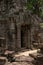 Temple doorway seen through gap in wall