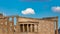 Temple of Erechtheion with the Caryatids statues in Acropolis, Greece against a blue sky