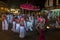 Temple priests and entourage walk along a street in Kandy at the completion of the Esala Perahera in Kandy, Sri Lanka.