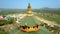 Temple upper storey green roof with dome against river