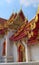 Temple of Wat Benchamabophit, located in Bangkok, Thailand. Architectural detail of the traditional styled rooftop and windows.