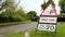 Temporary road signs saying Skid risk, Max speed 20mph, with a car approaching. Hertfordshire. England. UK