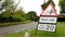 Temporary road signs saying Skid risk, Max speed 20mph, with a car driving past. Hertfordshire. England. UK