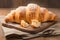 Tempting close up of a croissant bread elegantly arranged on wood