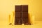 Tempting sweetness milk chocolate bar on yellow background, indulgent delight