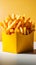 Tempting yellow box holds golden fries on a white backdrop