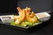 Tempura Deep Fried Shrimp Ebi with sweet chili and soy sauce on black board stone on dark background. Japanese food style