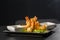 Tempura Deep Fried Shrimp Ebi with sweet chili and soy sauce on black board stone on dark background. Japanese food style