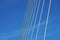Ten bridge cables stretch across blue sky