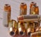 Ten different 40 caliber hollow point bullets together on a white wooden background