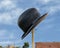 Ten foot tall and wide, 2-ton bowler hat sculpture by artist Keith Turman standing on an empty lot on Griffin Street in Dallas