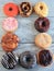 Ten frosted sprinkled dough nuts in frame Vertical