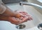 Ten out of ten for washing your hands. an unrecognisable man helping his child wash their hands in the sink at home.