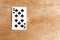 Ten of Spades on wooden background