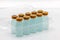 Ten vaccine bottles inside opened translucent plastic box