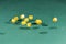 Ten yellow dices falling on a green table