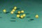 Ten yellow dices falling on a green table