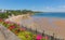 Tenby beach Wales uk in summer with beautiful bright pink and red flowers