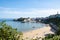 Tenby North  iconic beach sandy beach with the pinnacle of Goskar rock sticking out of the sand in the middle.