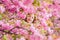 Tender bloom. Child on pink flowers of sakura tree background. Botany concept. Girl enjoying cherry blossom sakura. Cute