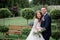 Tender brides pose in a beautiful garden