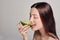 Tender brown-haired lady eating avocado