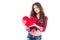 Tender charming young woman holding red heart
