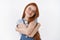 Tender cheerful redhead girl with long ginger hair tightly hug herself express self-love and care smiling broadly, close