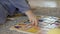 Tender childs hands playing wooden alphabet set on the carpet, close up