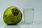 Tender coconut with a glass on a white table