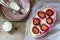 Tender curd casserole with plums and semolina, served with cinnamon and mint leaves on a wooden background