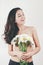 Tender cute beautiful summer young girl with topless body perfect skin. holds camomiles flowers. white background