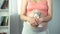 Tender emotions of pregnant woman hugging soft teddy bear, anticipation of baby