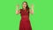 Tender girl in red dress is dancing funny. Green screen