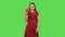 Tender girl in red dress drinking unpalatable coffee and is disgusted. Green screen