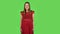 Tender girl in red dress is laughing. Green screen