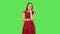 Tender girl in red dress is listening to information, shocked and very upset. Green screen