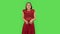 Tender girl in red dress is looking with tenderness smile. Green screen
