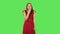 Tender girl in red dress is pointing herself, say who me no thanks i do not need and laughing. Green screen