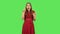 Tender girl in red dress is thinking about something, and then an idea coming to her. Green screen