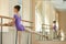 Tender girl training in ballet studio.