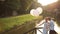 Tender moment of happiness. Young beautiful wedding couple with balloons embracing on the bridge sunset river on