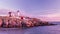 A tender morning with pink clouds on the coast of the Atlantic Ocean. lighthouse located on a rocky rock in the water.