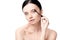 Tender naked brunette woman applying mascara