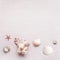 Tender natural cream colored shells on pale pink sand