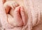 Tender newborn baby feet with tiny toes, macro